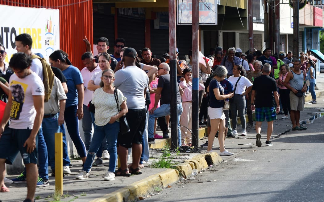 People queue at a store to get groceries in Caracas on January 3, 2026, after US forces captured Venezuelan leader Nicolas Maduro.
Mandatory Credit:	Jacinto Oliveros/AFP/Getty Images via CNN Newsource