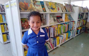 A local child in Kolovai village is excited about the opening of Tonga's first public library.
