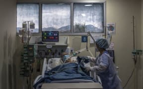 A health worker cares for a Covid-19 patient at an Intensive Care Unit (ICU) of the Ronaldo Gazolla Public Municipal Hospital in Rio de Janeiro, Brazil.