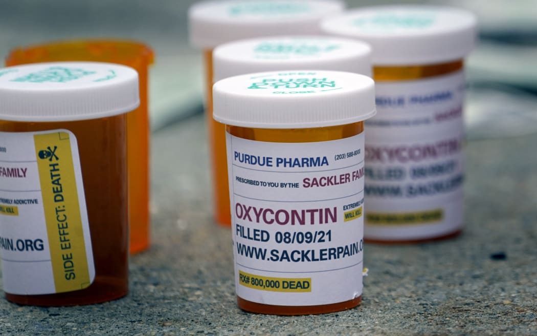 Fake pill bottles displayed during a protest outside the US Supreme Court during a hearing on Purdue Pharma's bankruptcy, in White Plains, New York on 9 August 2021.