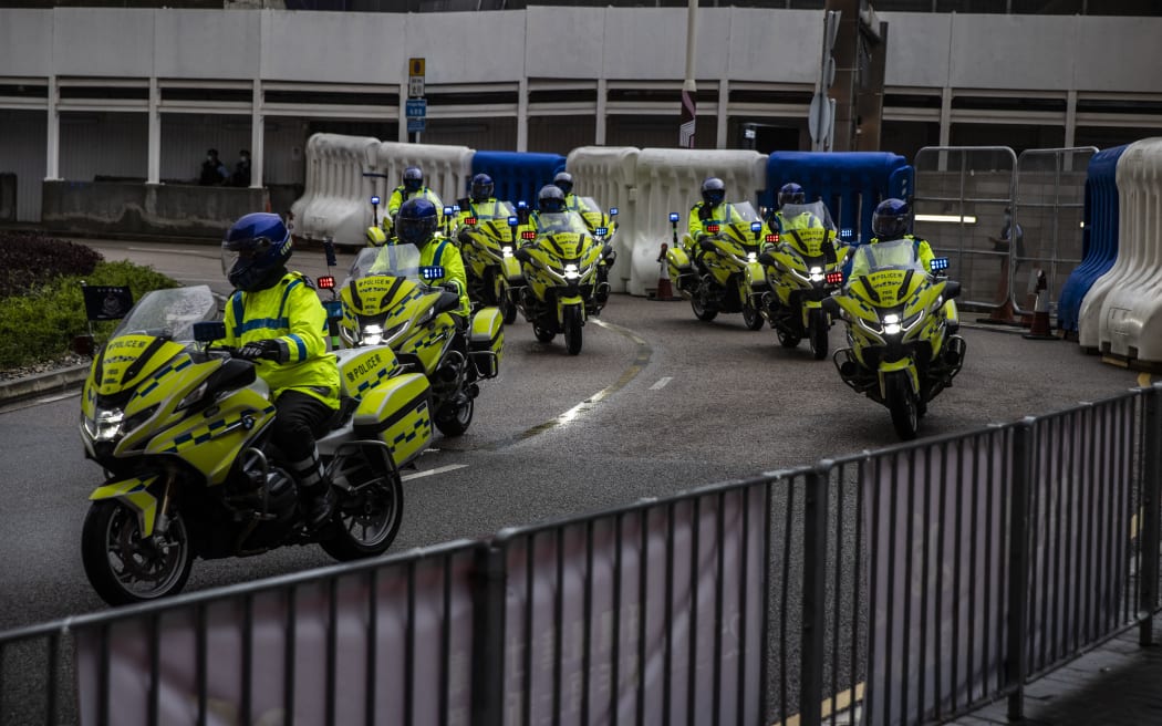 Motorcycle police patrol near West Kowloon Station in Hong Kong on June 30, 2022, as Chinese President Xi Jinping arrives in Hong Kong to attend celebrations marking the 25th anniversary of the city's handover from Britain to China.