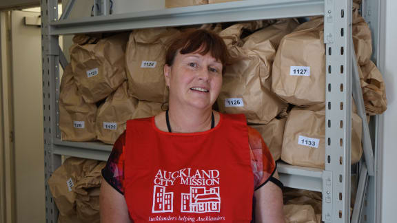 Alexis Sawyers standing in front of Christmas food parcels.