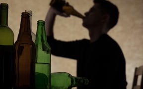 Teen chugging a beer.