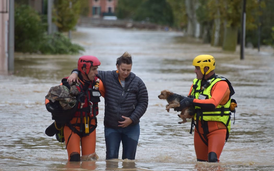 Firefighters helps a resident with a dog