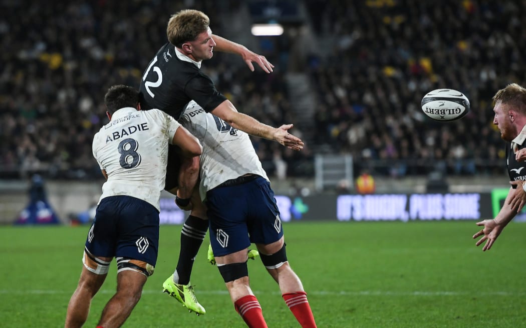 Jordie Barrett is tackled heavily against France.