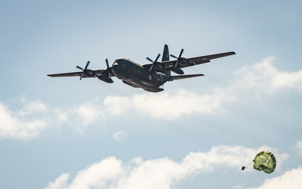 A Japan Air Self Defense Force C-130H Hercules assigned to the 401st Tactical Airlift Squadron flies over a drop zone during practice airdrop operations near Andersen Air Force Base, Guam, as part of Operation Christmas Drop 2022.