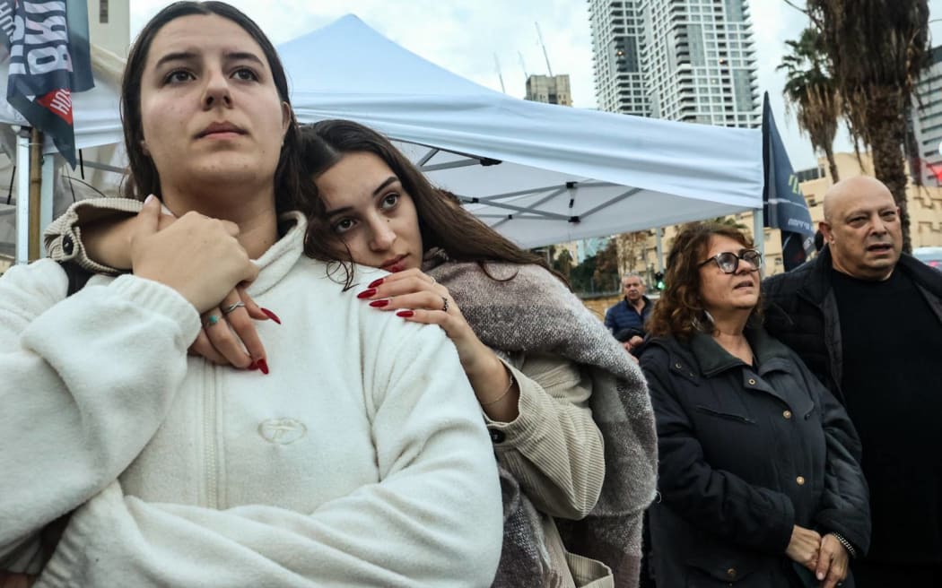 People gather in Tel Aviv to mark the 100th day after an unprecedented attack by Hams fighters on Israel that was followed by a war between Israel and the Palestinian Hamas movement, on January 14, 2024. The war in Gaza started on October 7 when Hamas militants launched an attack from the Gaza Strip that resulted in about 1,140 deaths in Israel, mostly civilians, according to an AFP tally based on official figures.The conflict has triggered a humanitarian crisis, with more than 23,000 people reported killed in Gaza and much of the besieged Palestinian territory reduced to rubble, as fears grow that fighting could engulf the wider region. (Photo by GIL COHEN-MAGEN / AFP)