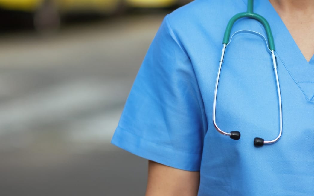 Nurse treating an inmate in a secure medical setting
