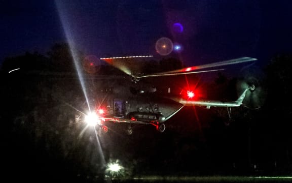 A helicopter lands at a military airport in Chiang Rai with its passengers taken by ambulance to nearby hospital as divers evacuated some of the 12 boys.