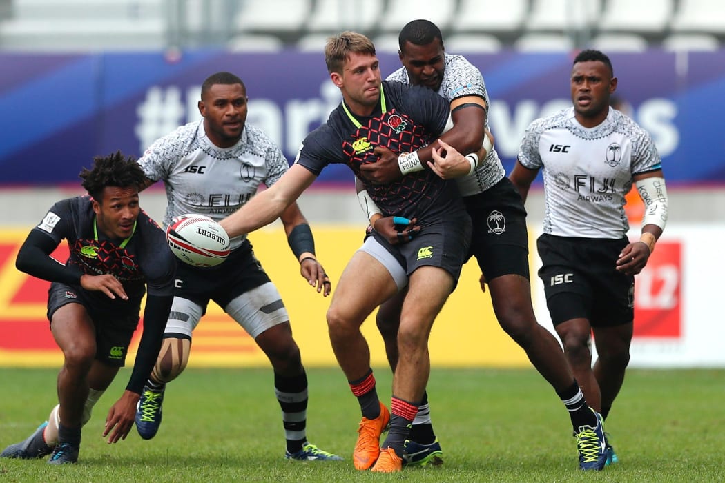 England's Harry Glover offloads against the Fiji in their quarter final clash in Paris.