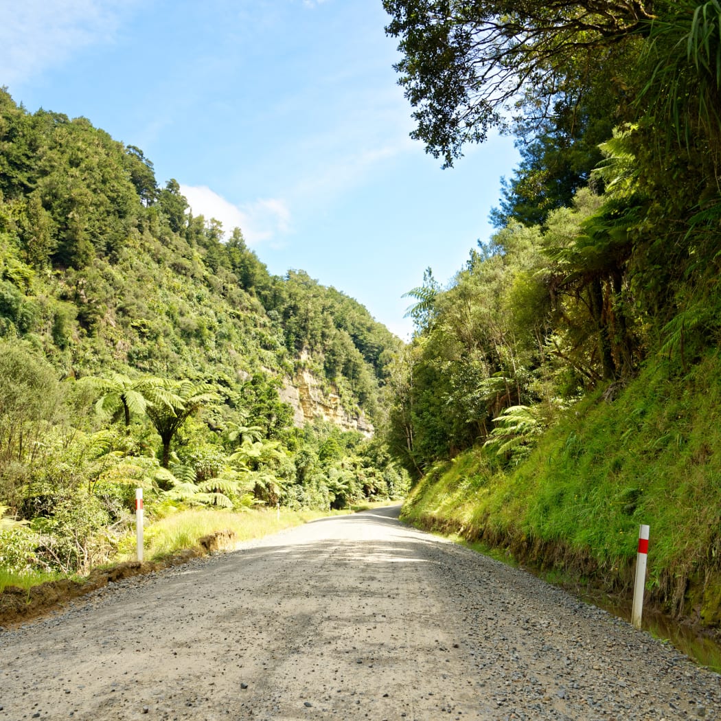 Lonely scenic highway through farmland in Taranaki, New Zealand