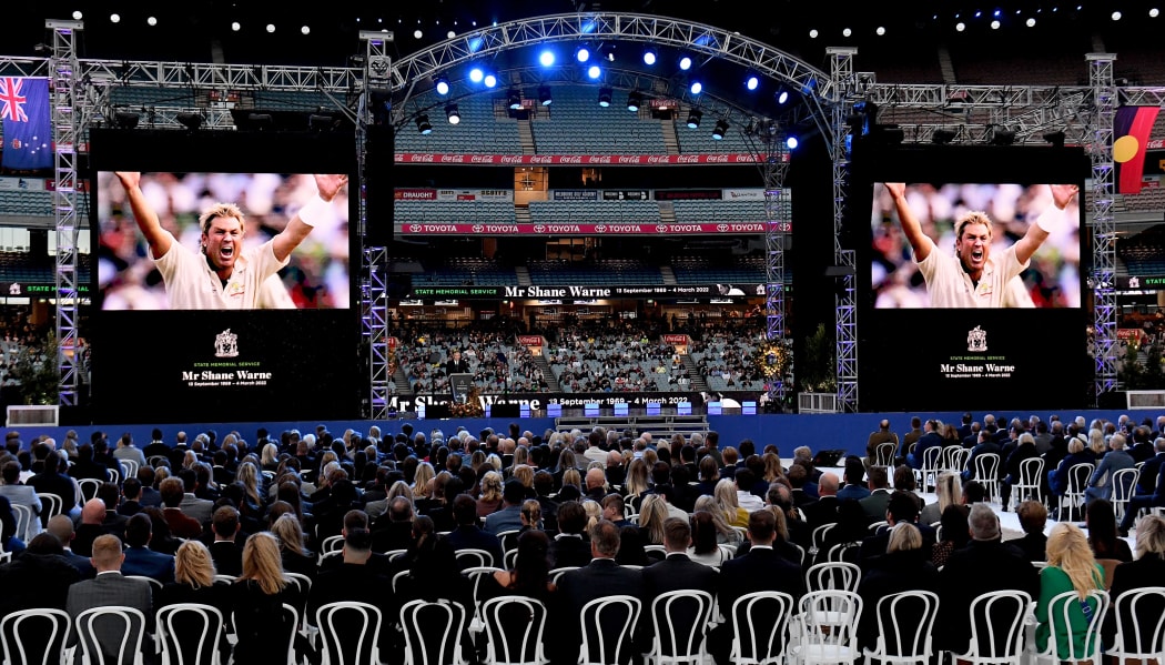 People gather to attend the state memorial service for the former Australian cricketer Shane Warne at the Melbourne Cricket Ground (MCG) in Melbourne on March 30, 2022.