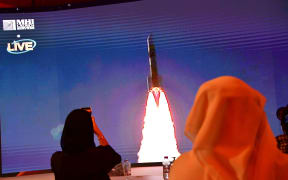 A picture taken on July 19, 2020, shows a screen broadcasting the launch of the 'Hope' Mars probe at the Mohammed Bin Rashid Space Centre in Dubai, UAE