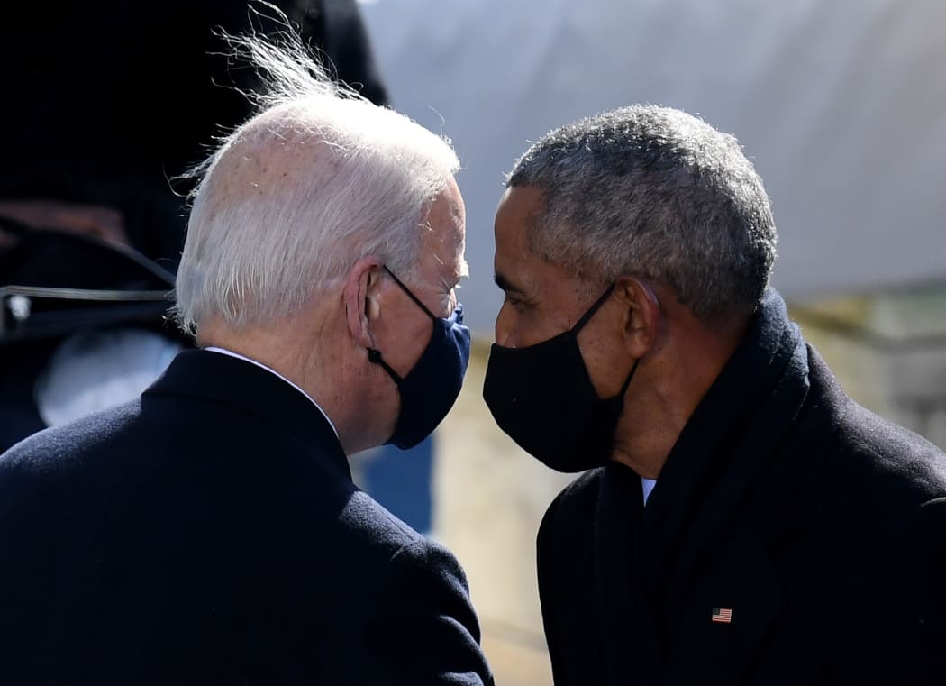 US President Joe Biden speaks with former US President Barack Obama during his inauguration as the 46th US President on January 20, 2021, at the US Capitol in Washington, DC. (Photo by OLIVIER DOULIERY / AFP)