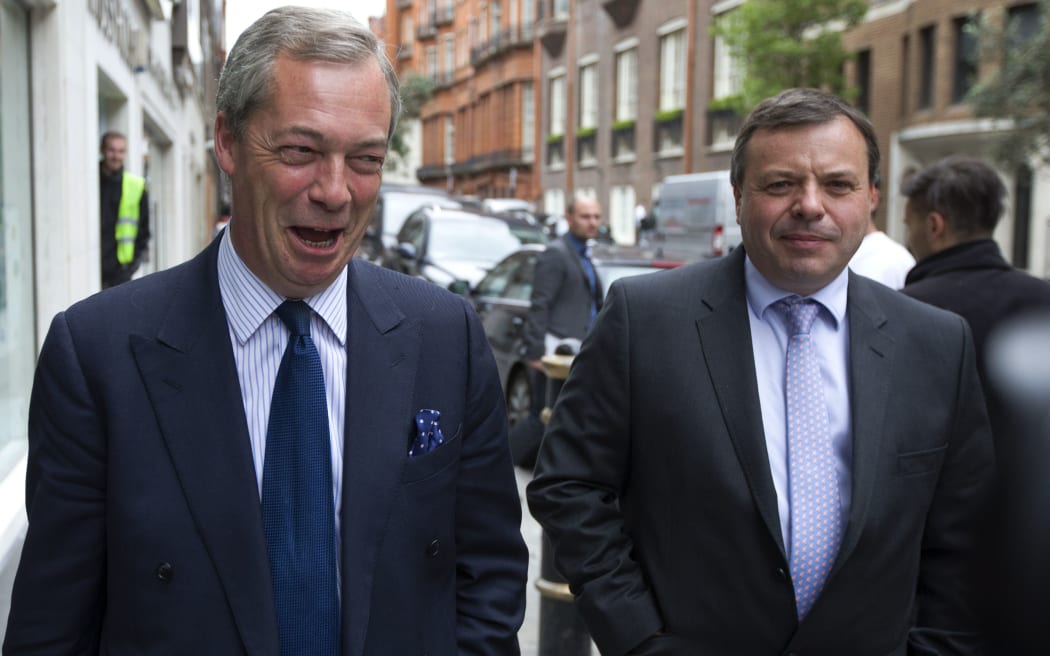 UK Independence Party (UKIP) leader Nigel Farage (L) and major donor Arron Banks leave the party's head office in central London on May 15, 2015.