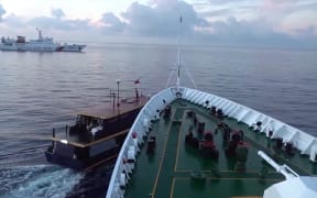 In this video grab taken from a video released by the Chinese Coast Guard (CCG) through the Chinese embassy in Manila on 23 October, 2023 shows a collision between Chinese Coast Guard ship (R) and Philippines' resupply boat (L) during a resupply mission in Second Thomas Shoal, in the disputed South China Sea. Beijing and Manila traded blame on October 22, for two collisions between Chinese vessels and Philippine boats on a resupply mission to Filipino troops on a remote outpost in the disputed South China Sea. (Photo by Handout / Chinese Coast Guard / AFP) / RESTRICTED TO EDITORIAL USE - MANDATORY CREDIT "AFP PHOTO / Chinese Coast Guard"  - NO MARKETING NO ADVERTISING CAMPAIGNS - DISTRIBUTED AS A SERVICE TO CLIENTS