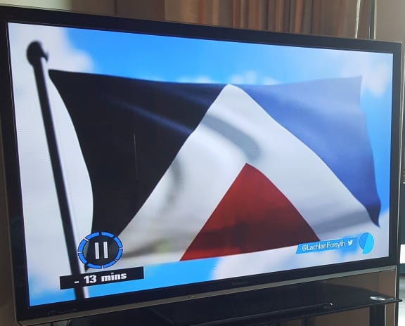 Picture of a flash-frame of Red Peak flag on TV3 during a report by Lachlan Forsyth . . . a fan of the design.