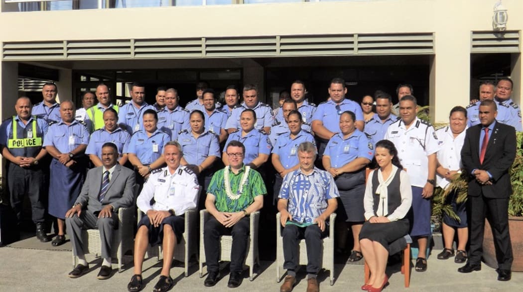 The British High Commissioner, (front centre), the Police Commissioner, (front left in white) and UNDP Representatives alongside officers at the training