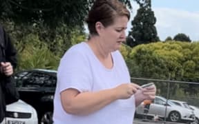 Elizabeth Audrey Donohue, known as Liz, arrives at the Pukekohe District Court with family this afternoon for sentencing on charges relating to the theft of $522k from her former employer.
