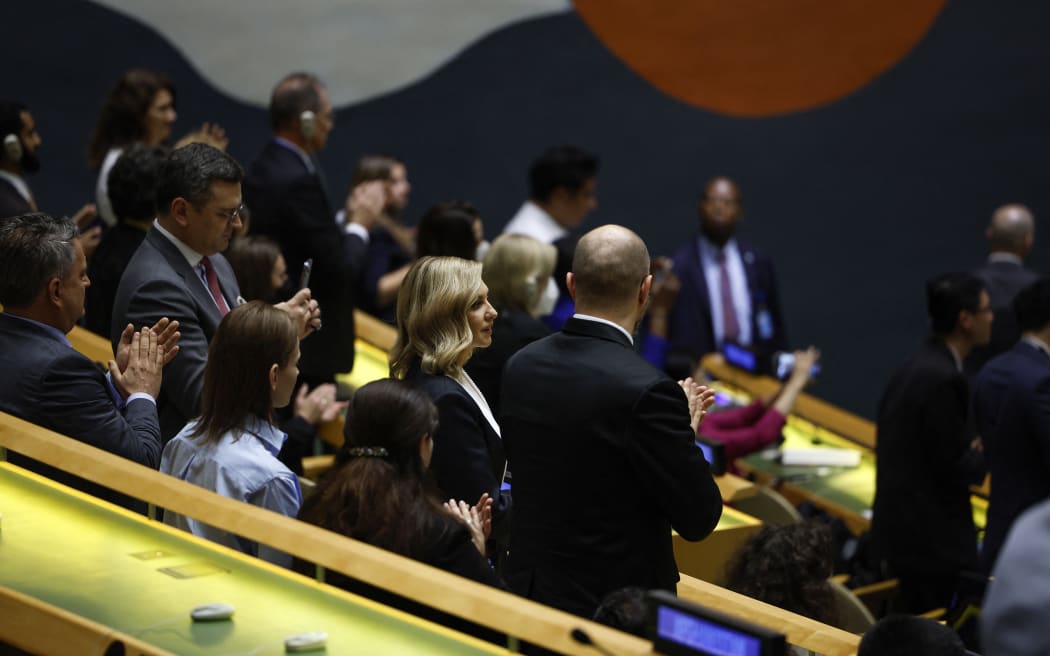 Ukrainian first lady, Olena Zelenska (centre) stands to applaud alongside delegates following the end of a pre-recorded speech by Ukrainian President Volodymyr Zelensky during the 77th session of the United Nations General Assembly (UNGA) at the UN headquarters in New York City on 21 September, 2022.