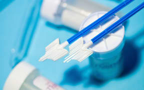 A brush and vials used in vaginal smear testing