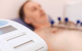 Magical machinery. Man making sure his heart is functioning without problems by examining it using special equipment