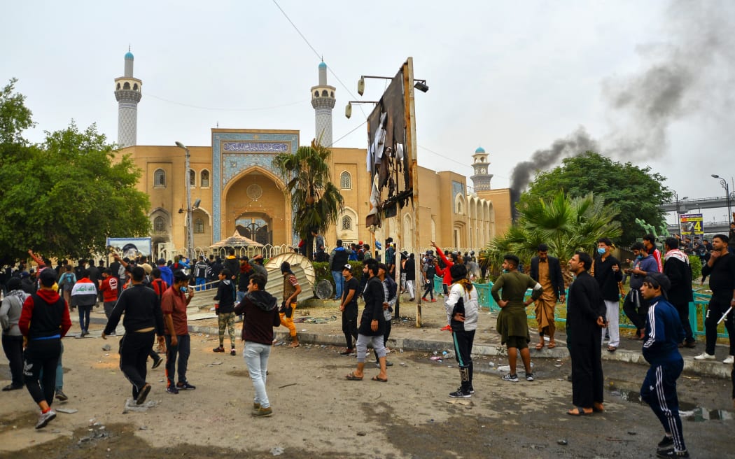 Iraqi demonstrators gather in front of the shrine dedicated to the late Iraqi Shia Ayatollah Mohammed Baqir al-Hakim in the southern Iraqi Shia holy city of Najaf on December 1, 2019, during anti-government demonstrations