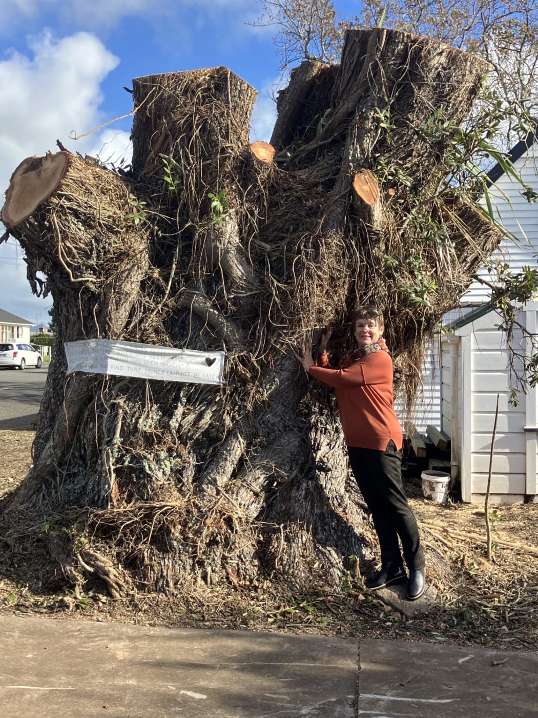 Ballance Street resident Kirsty Porter gives the remnants of the pōhutukawa a hug.
