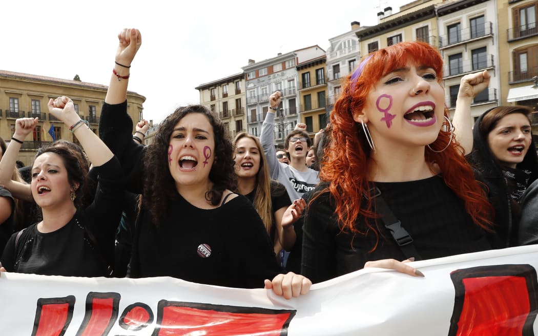 People shout slogans during a protest in Pamplona on April 28, 2018