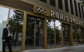 A security member stands at the entrance of the headquarters of the Paris 2024 Olympics headquarters as Police raided just over a year out from the opening ceremony of the quadrennial sporting showpiece, in Saint-Denis, northern Paris, on June 20, 2023.