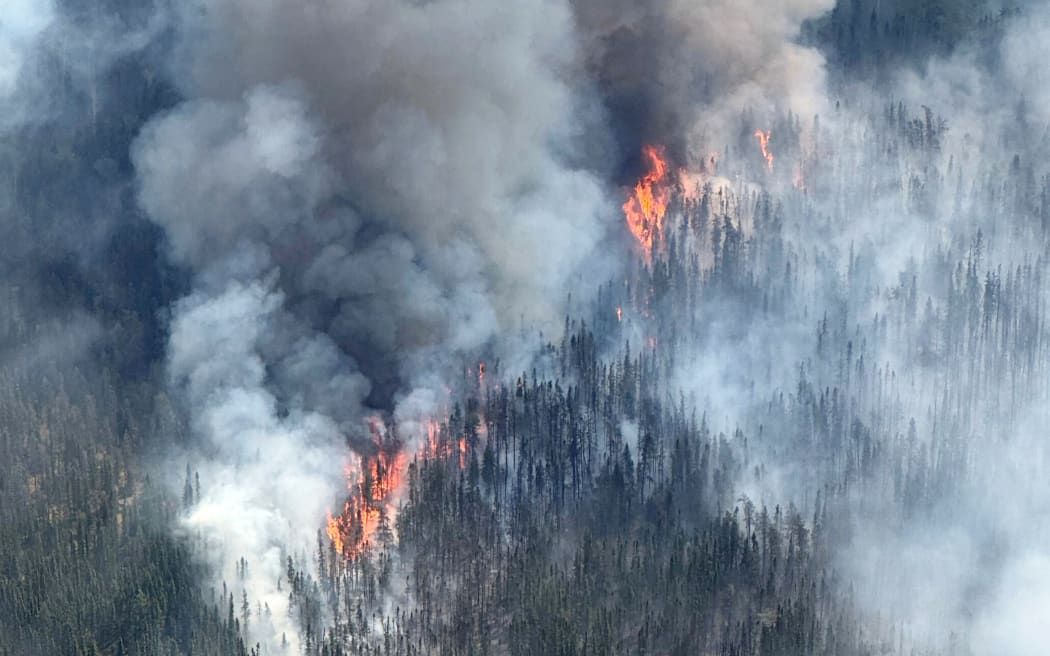 This handout photo released by the Ontario Ministry of Natural Resources on June 16, 2025 and taken on June 14, 2025 shows active fire behavior near Kennedy Lake, east of Deer Lake First Nation, as the Red Lake 12 fire continues to burn in northern Ontario, Canada. Two years after a historically devastating summer, Canada is once again facing a massive fire season, with burned areas already exceeding year-to-date averages from recent years. (Photo by Ontario Ministry of Natural Resources / AFP) / RESTRICTED TO EDITORIAL USE - MANDATORY CREDIT "AFP PHOTO / ONTARIO MINISTRY OF NATURAL RESOURCES " - NO MARKETING - NO ADVERTISING CAMPAIGNS - DISTRIBUTED AS A SERVICE TO CLIENTS
