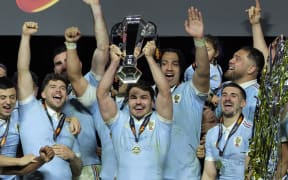 France's captain Antoine Dupont lifts the Six Nations Trophy alongside teammates as they celebrate winning the Six Nations championship at the end of the match against England at the Stade de France, in Saint-Denis, north of Paris, on March 14, 2026. (Photo by Thomas SAMSON / AFP)