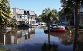 CLEARWATER, FLORIDA - OCTOBER 10: Cars are flooded in an apartment complex after the arrival of Hurricane Milton on October 10, 2024 in Clearwater, Florida. Milton, which comes just after the recent catastrophic Hurricane Helene, landed into Florida's Gulf Coast late Wednesday evening as a Category 3 storm causing extensive flooding and damage.   Spencer Platt/Getty Images/AFP (Photo by SPENCER PLATT / GETTY IMAGES NORTH AMERICA / Getty Images via AFP)