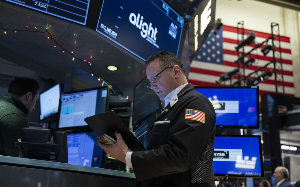 Traders work on the floor of the New York Stock Exchange (NYSE) during morning trading on January 3, 2024, in New York City.