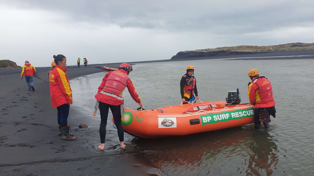 Surf lifesaving teams from Raglan and Taranaki prepare to enter the water at Marokopa to start a coastline search from the ocean.