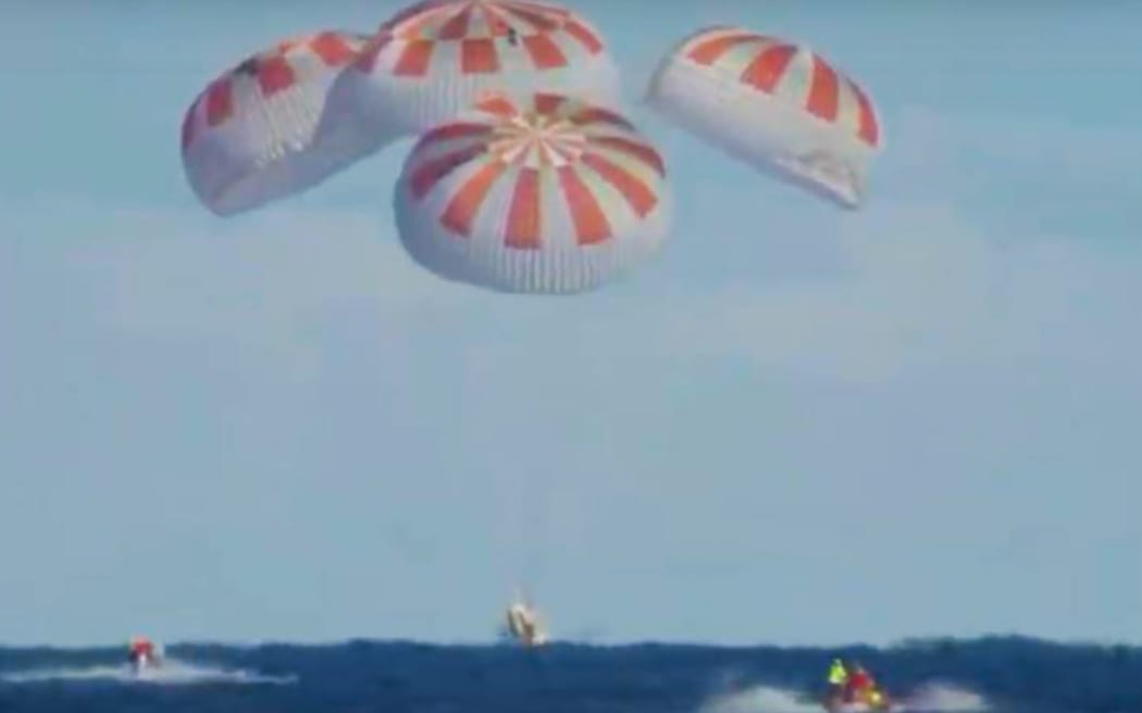 This video grab taken from the Nasa - Space X webcast transmission on March 8, 2019, shows SpaceX Dragon capsule successfully splashed down in the Atlantic Ocean today after more than six days in space, completing its demonstration mission for US space agency NASA.