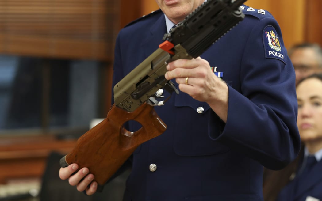 Acting Superintendant Michael McIlraith demonstrates how semi-automatic weapons can be illegally modified