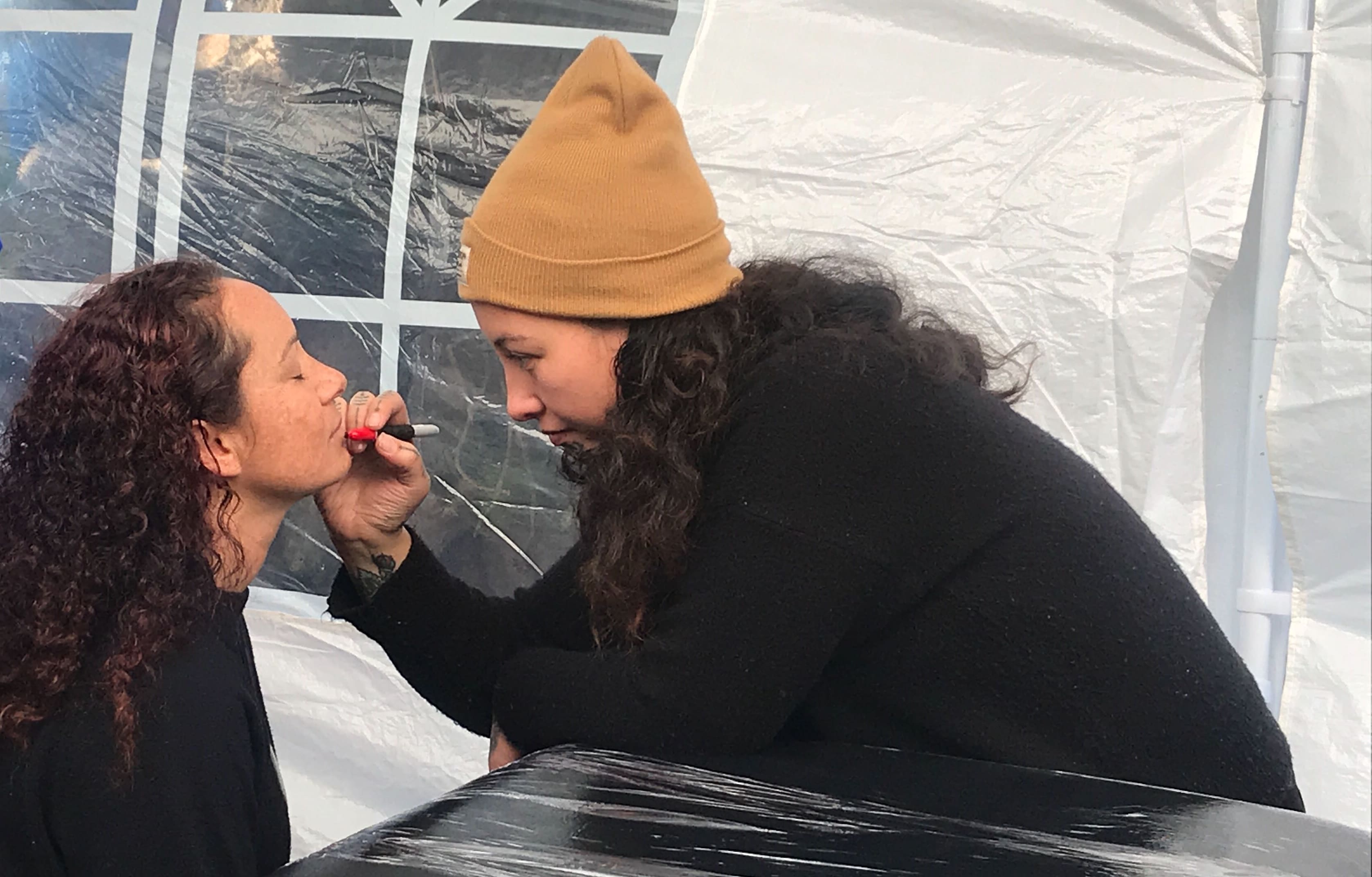 Tyler-Jade prepares Harmony Smith for her moko kauae at Ihumātao.