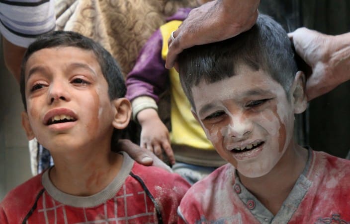 Syrian boys cry following Russian air strikes on the rebel-held Fardous neighbourhood of the northern embattled Syrian city of Aleppo.