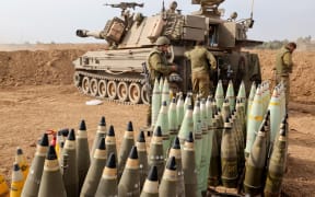 Artillery shells are lined up next to an armoured vehicle as Israeli soldiers take positions near the border with Gaza in southern Israel on October 9, 2023. Stunned by the unprecedented assault on its territory, a grieving Israel has counted over 700 dead and launched a withering barrage of strikes on Gaza that have raised the death toll there to 493 according to Palestinian officials.