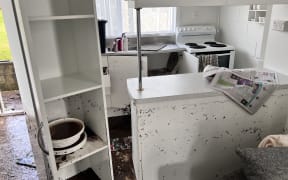 Floodwater left mud through a pensioner unit at Waihī Beach.