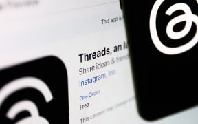 Threads on App Store displayed on a laptop screen and Threads logo displayed on a phone screen are seen in this illustration photo taken in Krakow, Poland on July 4, 2023.