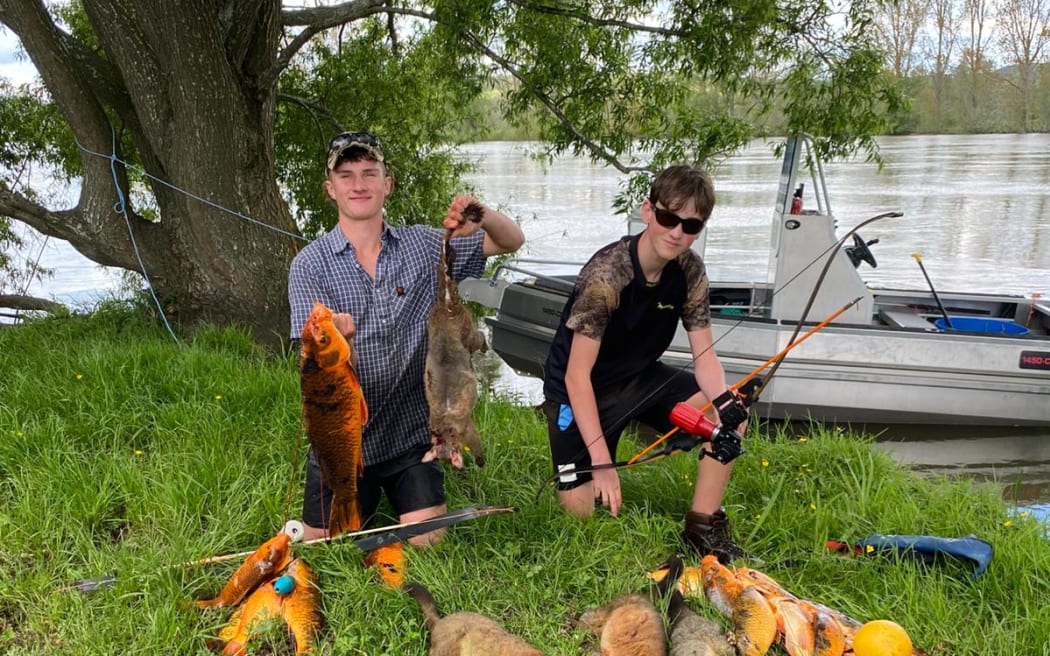 Bow hunters pose with their catch