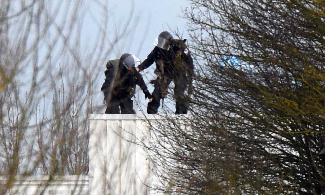 Police take up a position on a roof in Dammartin-en-Goele, north-east of Paris.