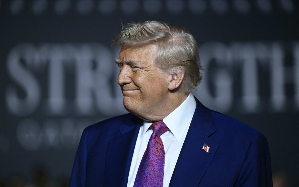 US President Donald Trump arrives to address troops at the Al-Udeid air base southwest of Doha on May 15, 2025. (Photo by Brendan SMIALOWSKI / AFP)