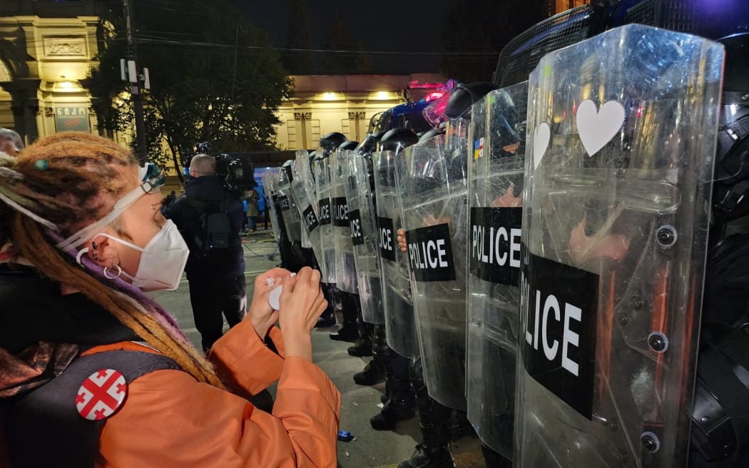 Georgian riot police stand outside Georgia's Parliament in Tbilisi early on March 9, 2023 during a rally called by Georgian opposition and civil society groups against a planned "foreign agent" law reminiscent of Russian legislation used to silence critics.