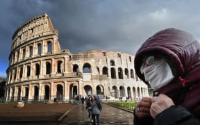Italy's popular tourist spots like the Colosseum in Rome are nearly deserted as a nationwide ban on public gatherings takes effect.