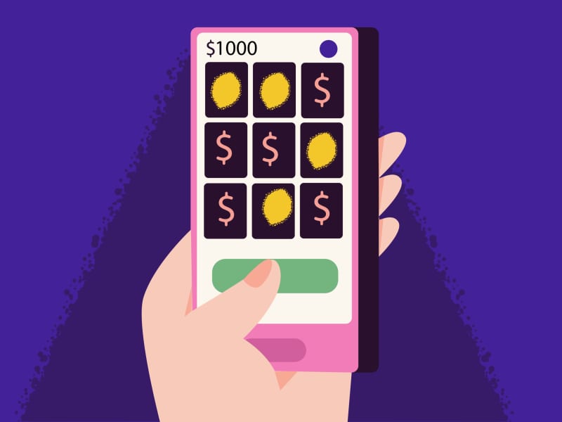 a hand holding a phone with an online gambling platform on it.