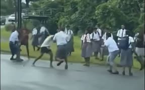 More than a dozens young students in uniform and can be seen brawling on the main road, with coming to a stand-still. on 11 February 2025.