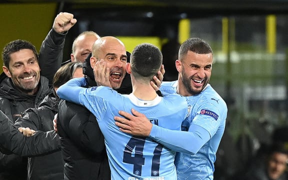 Pep Guardiola celebrates with Manchester City players.